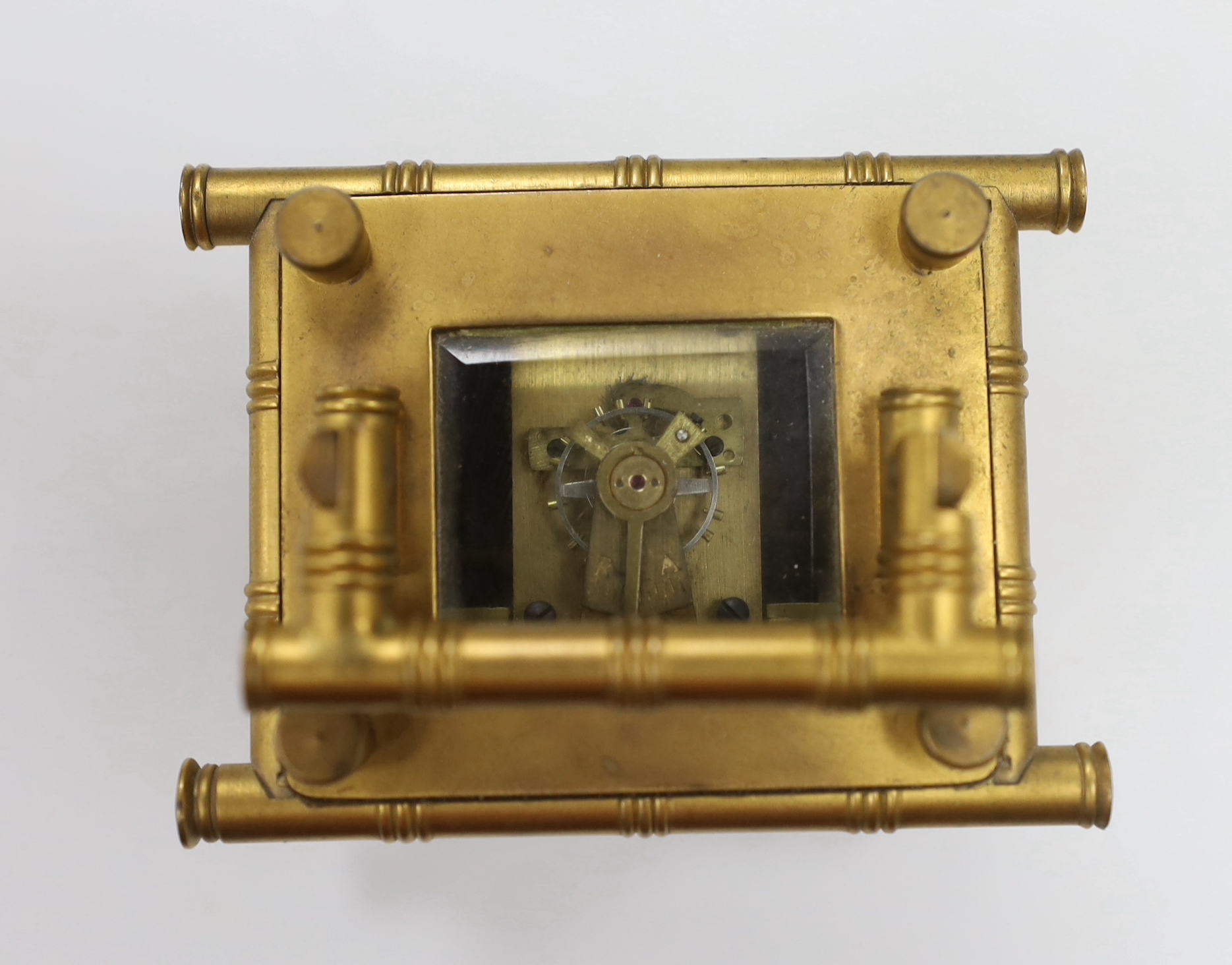 A French bamboo design carriage clock, with three porcelain putti decorated sides, by Elliot & Son, London, 9.5cm high